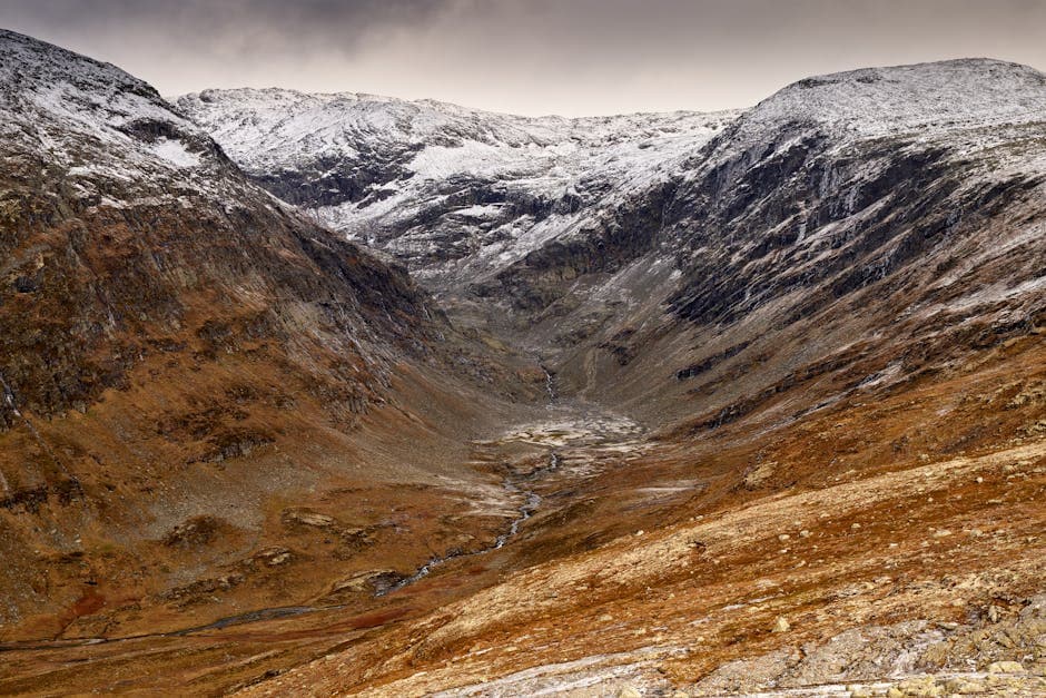 Breathtaking winter scene of a snowy mountain valley in Norway's rugged wilderness