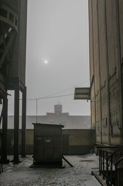 Abandoned industrial buildings in fog, similar to the former TNT munitions area near Point Pleasant, West Virginia