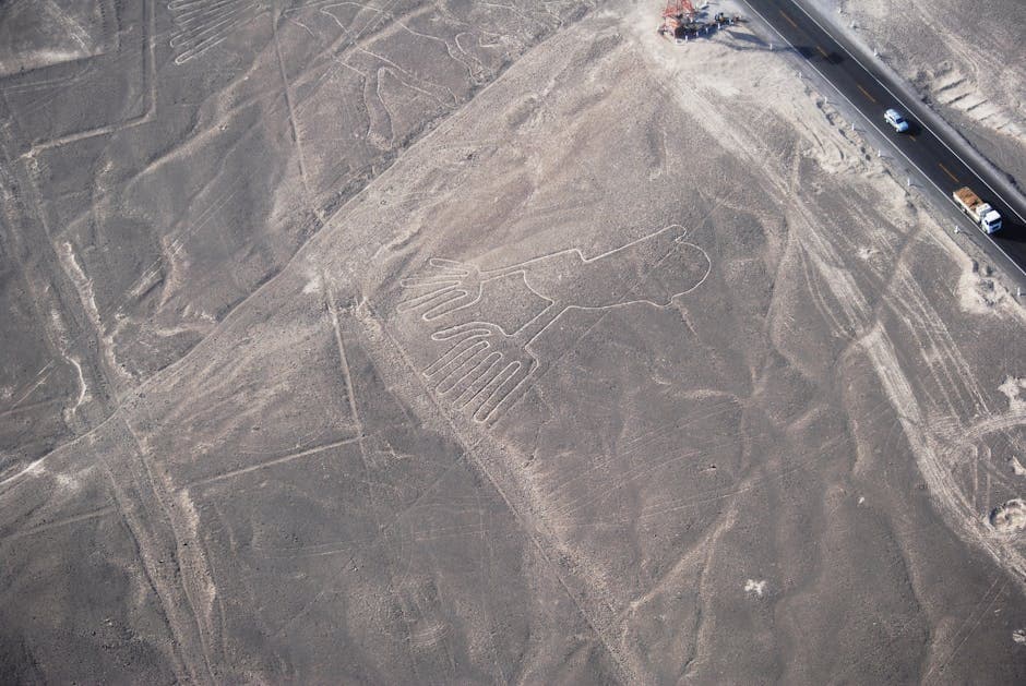 Drone shot showing Nazca Lines geoglyphs stretching across Peru's vast desert landscape