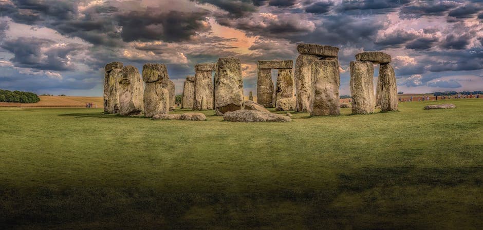 Panoramic view of Stonehenge's ancient megalithic stones under dramatic skies in Wiltshire, England
