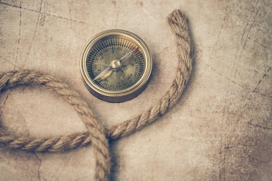 A vintage compass and rope resting on an old navigation map, evoking maritime exploration in the age of the Bermuda Triangle legend